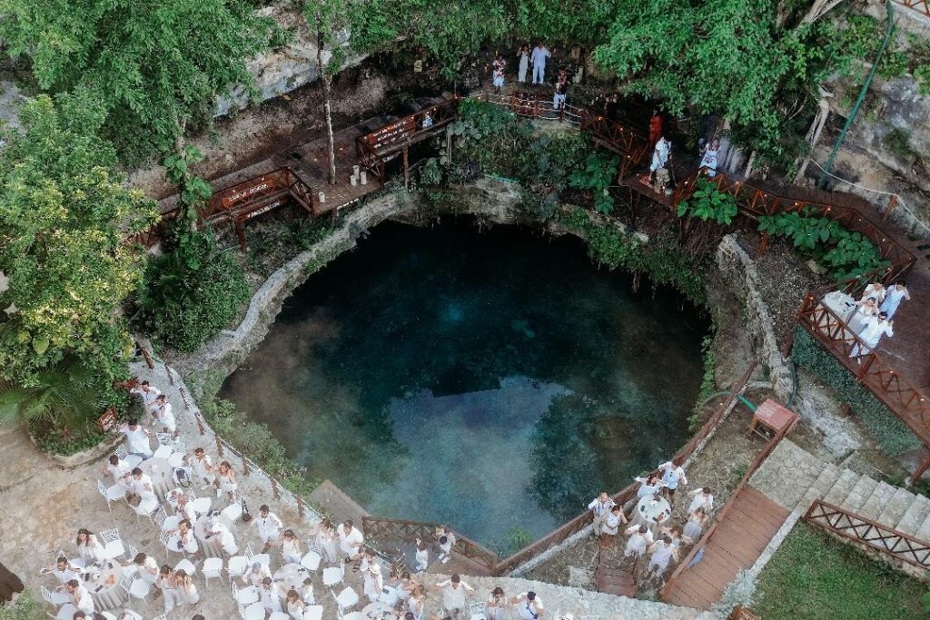 Top view of a circular cenote surrounded by lush jungle in Quintana Roo, ideal for destination weddings