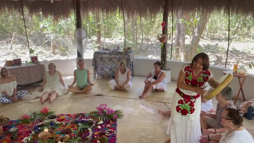 Cacao ceremony altar laid out under a palapa