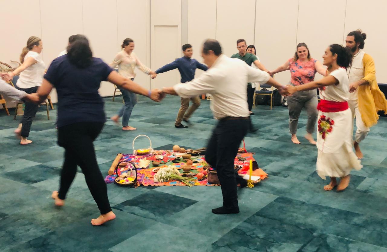 Colleagues dancing in a circle during a team building activity