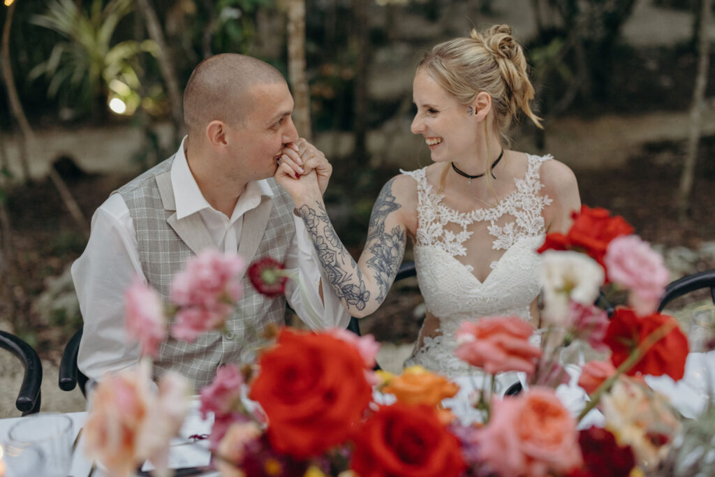 Bride and groom sharing intimate moment during destination wedding reception in Riviera Maya