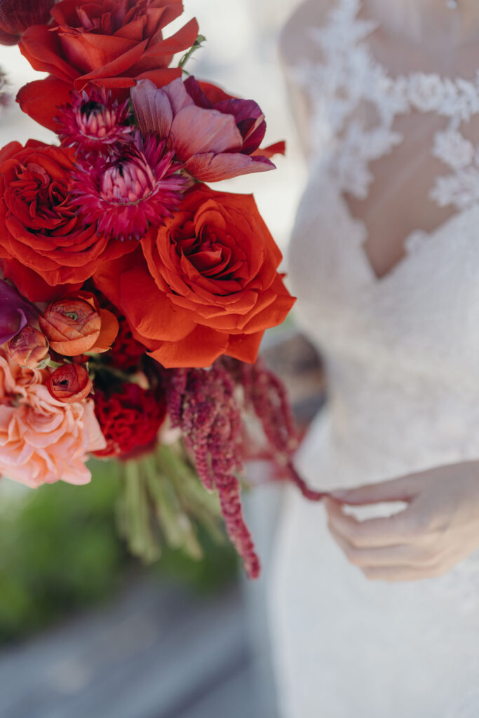 Close-up of vibrant red bridal bouquet during spiritual destination wedding in Tulum Riviera Maya