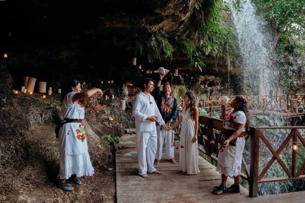 Small group gathered for an intimate cenote wedding ceremony in the Mayan jungle